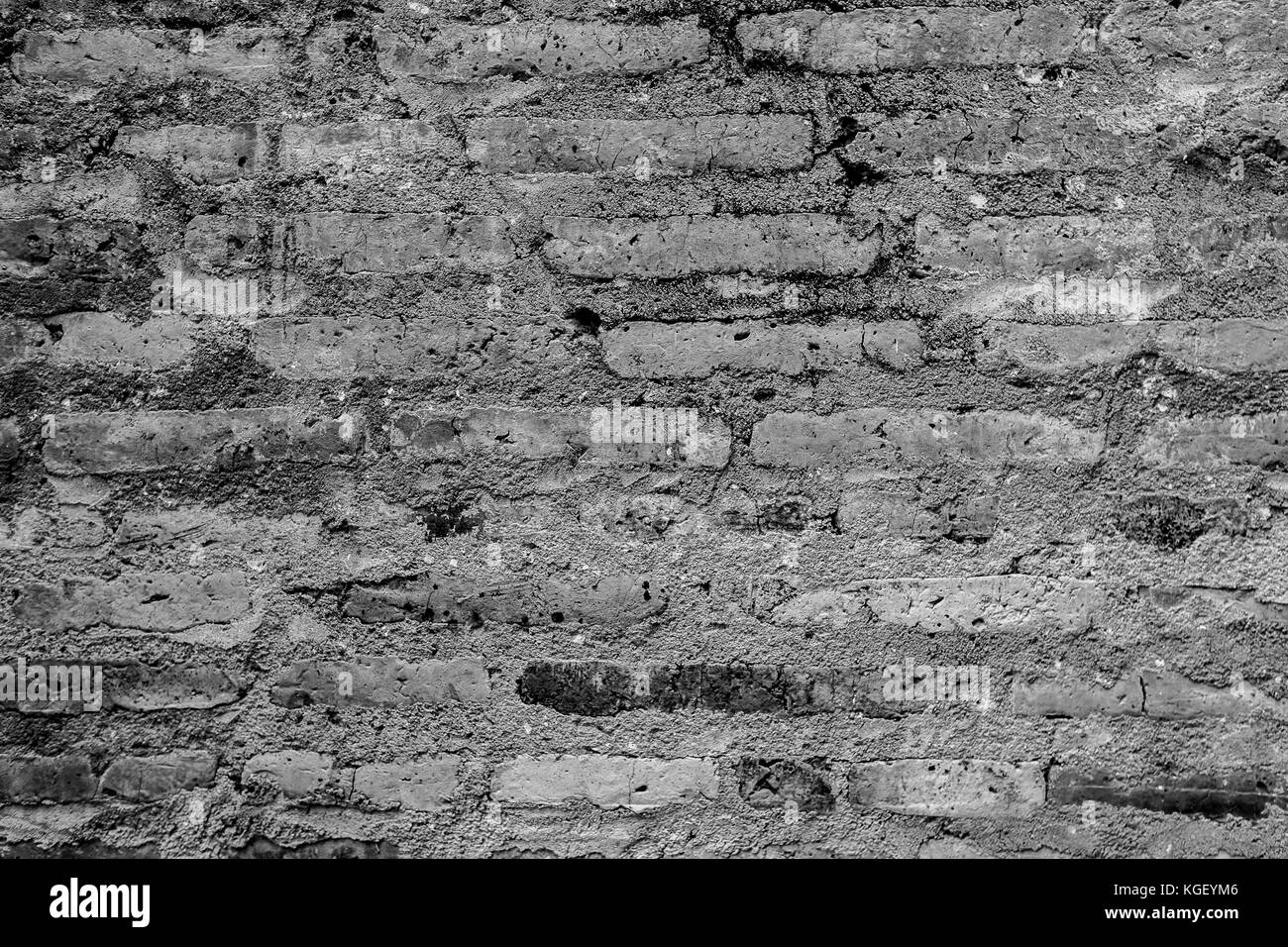 B&w texture di un vecchio orange parete di mattoni. Foto Stock