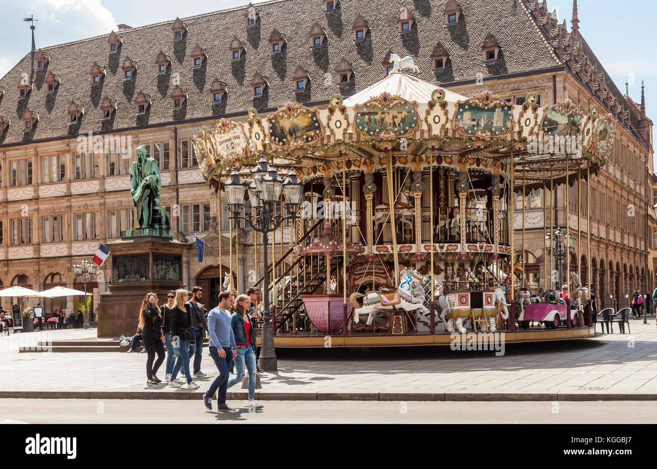 Place Gutenberg, Strasburgo. Persone che passano il carosello a due piani, la statua della stampante, Johannes Gutenberg. Alsazia, Francia. Foto Stock