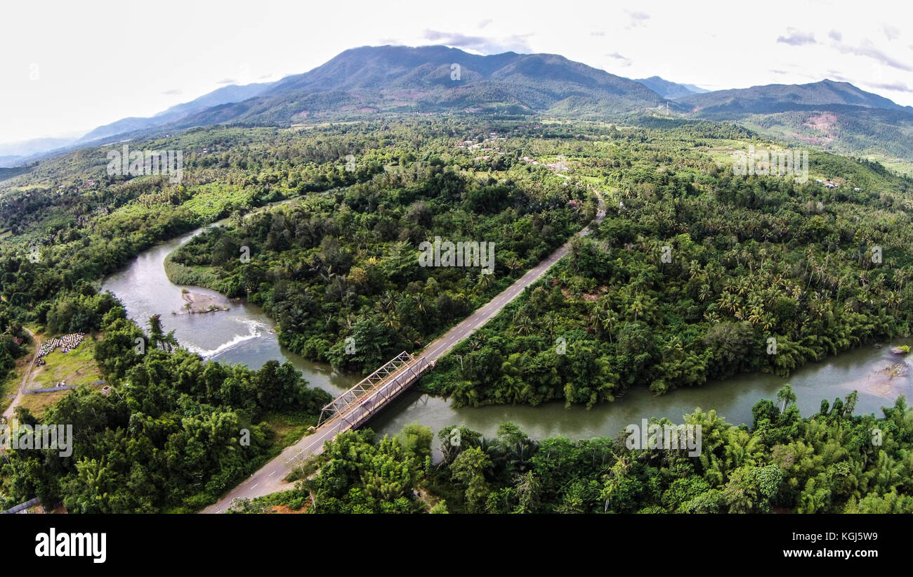 Infrastruttura di ponte nell isola di Sulawesi - indonesia con nichel verbeek mountain in background. Foto Stock