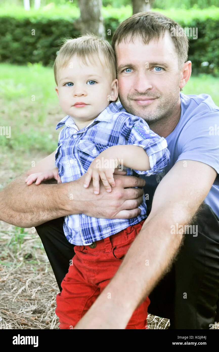 Il padre e il Figlio insieme con gli stessi occhi blu, guardare la fotocamera Foto Stock