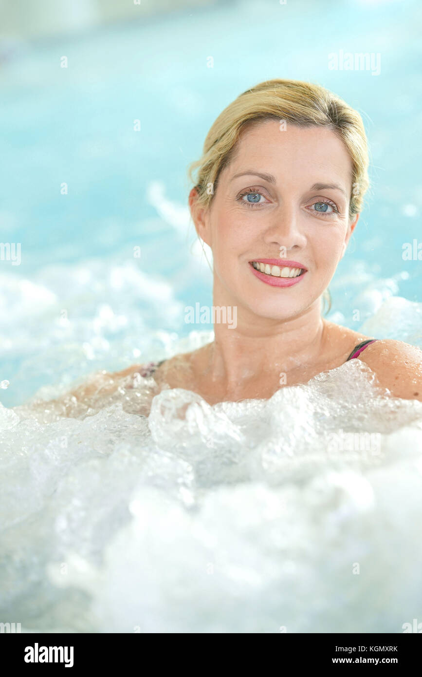 Donna di mezza età godendo il bagno termale nel centro di talassoterapia Foto Stock