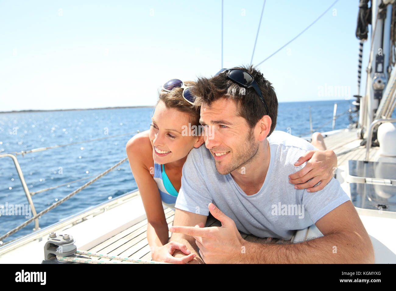 Giovane rilassante sul ponte di barche a vela Foto Stock