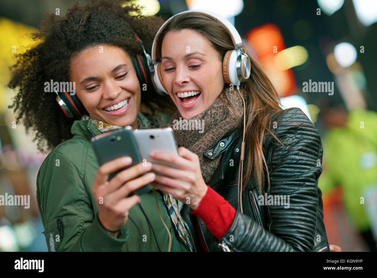 Ragazze ascoltando la musica con lo smartphone Foto Stock