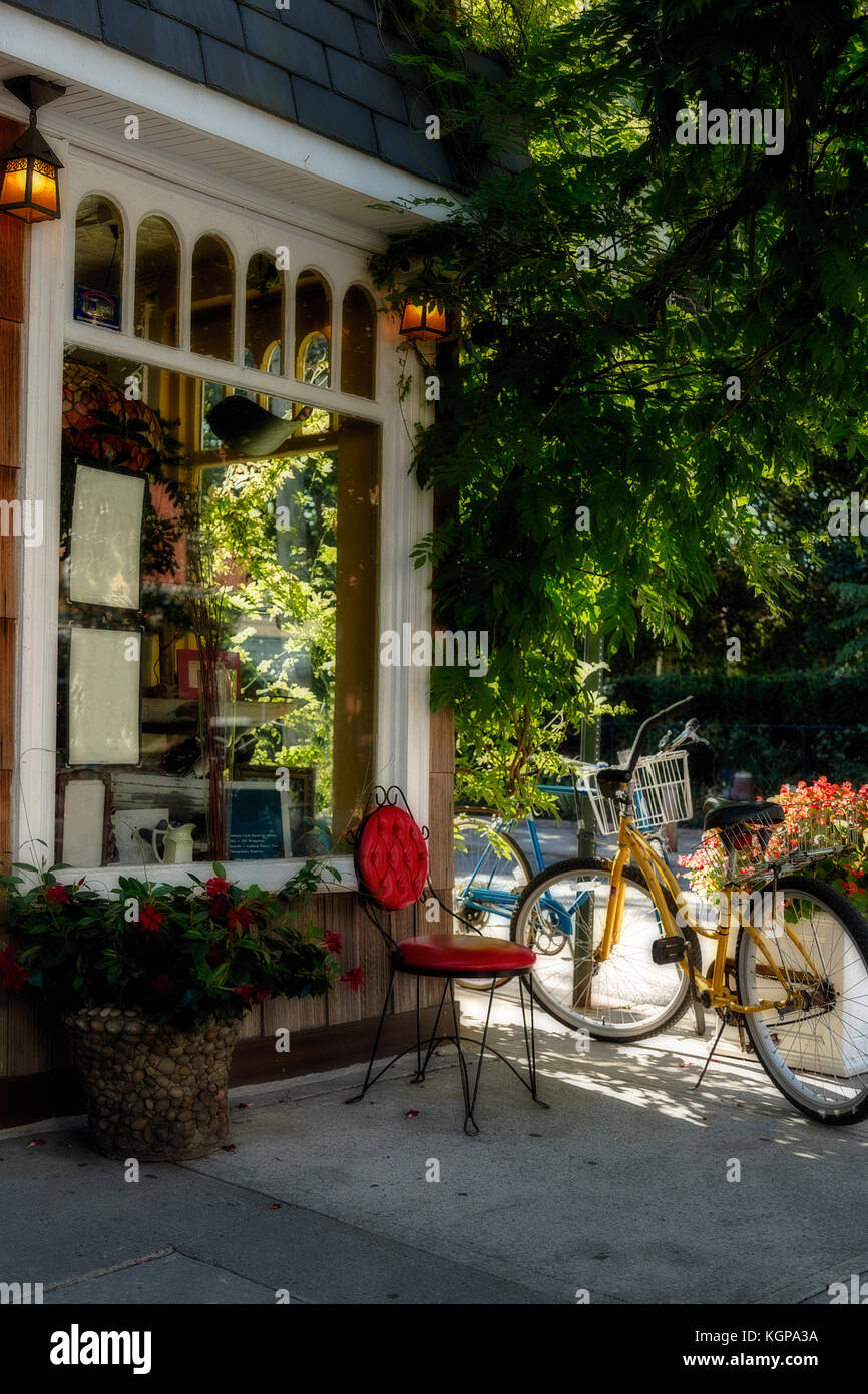 Dettaglio di una vecchia vetrina o il ristorante. bici e sedia rossa nella parte anteriore Foto Stock