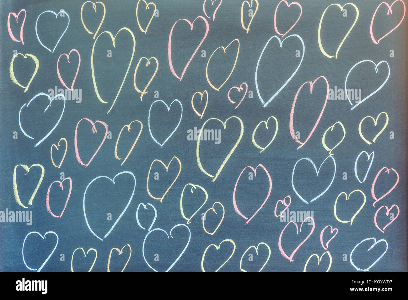 Più cuore forme disegnate su una lavagna sfondo. Foto Stock