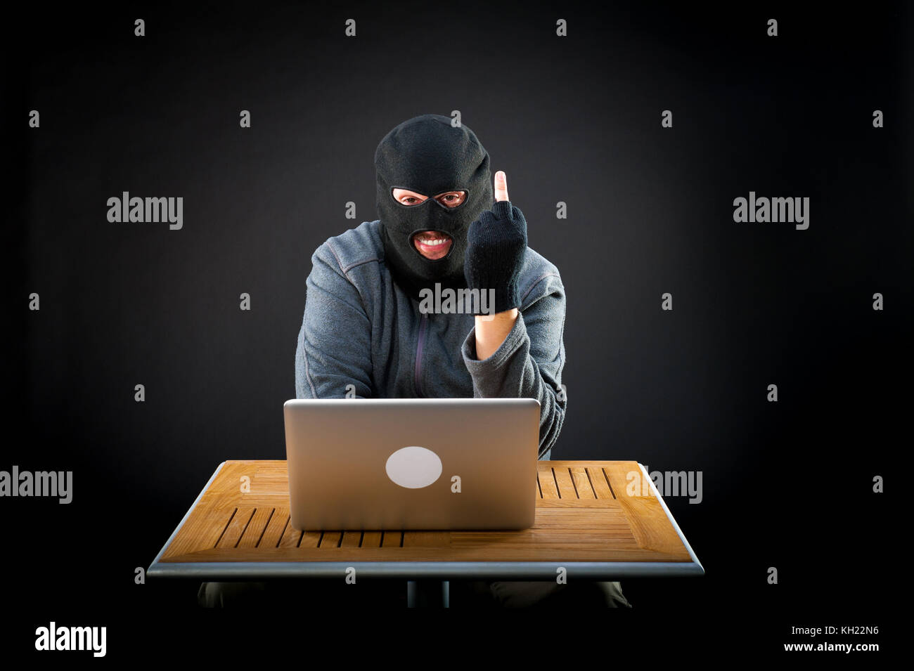 Sfacciato hacker che mostra il dito medio Foto Stock