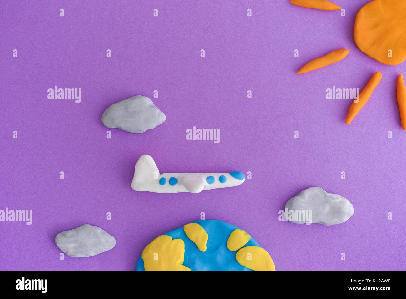 Aereo di volare intorno alla terra. terra, aereo e sun con le nubi sono realizzati fuori gioco di argilla (plastilina). Foto Stock