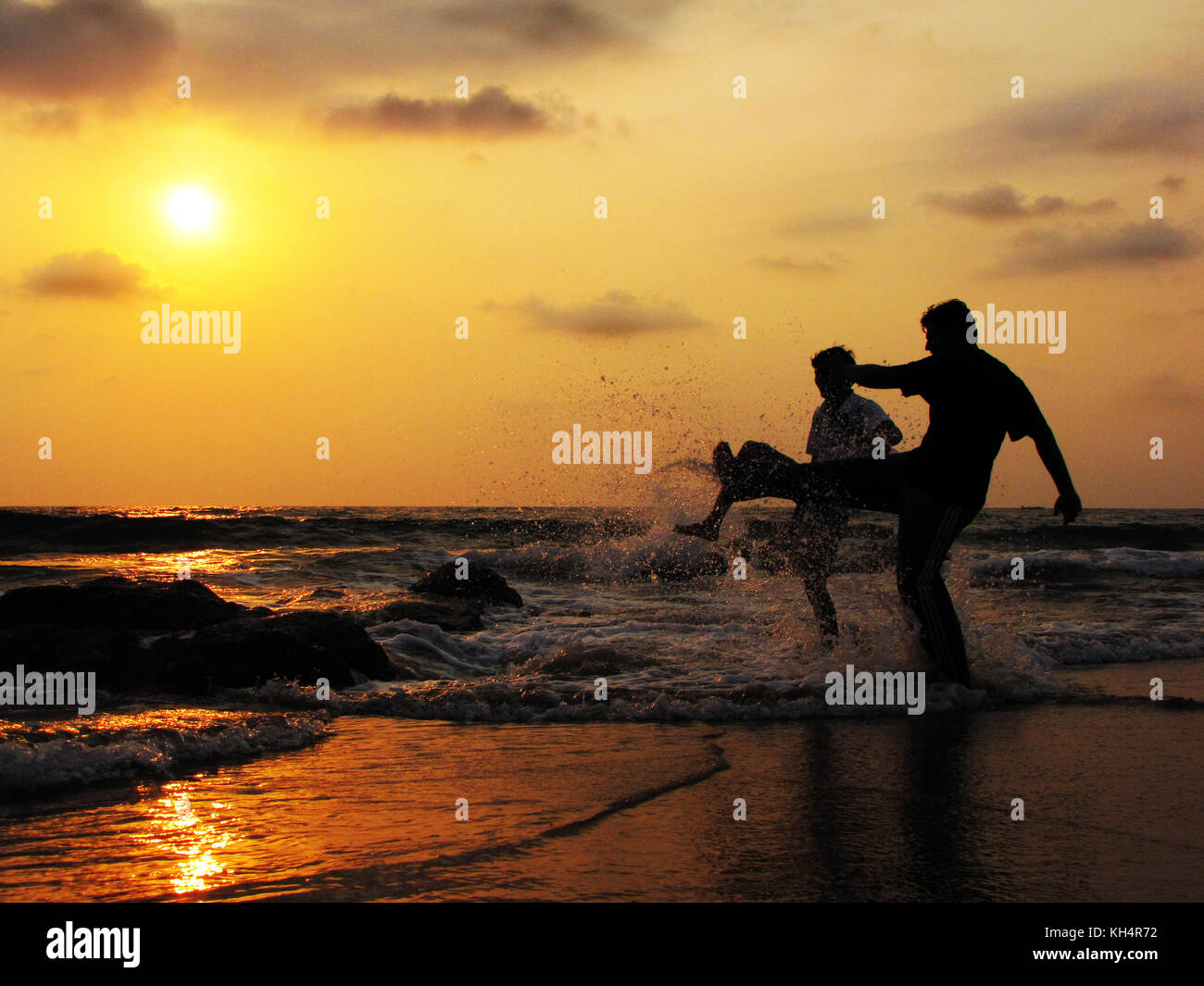 I ragazzi di giocare con le onde a gokarna beach in India del sud. Foto Stock
