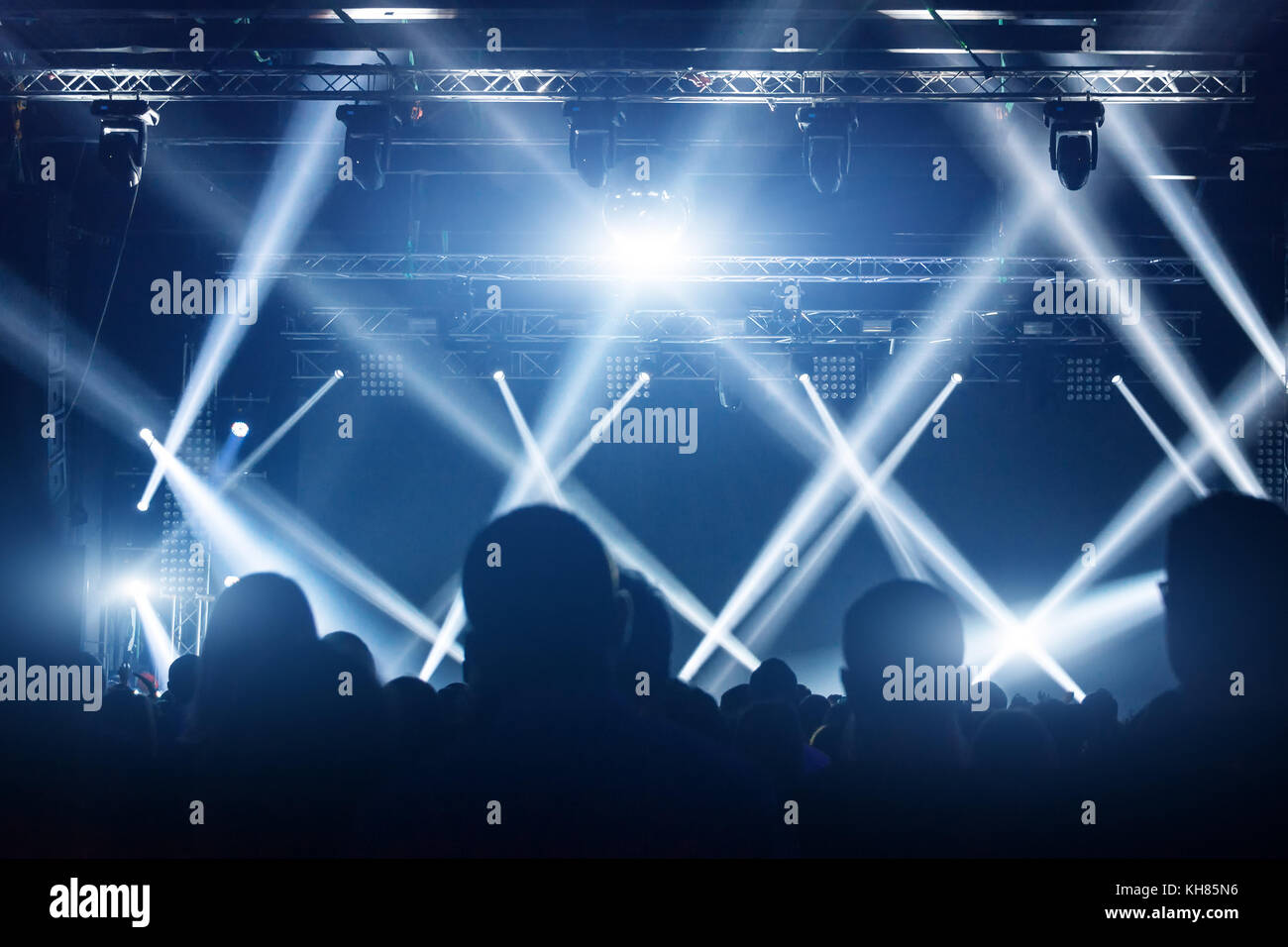 Folla di concerti. Le persone si stagliano davanti alle luci luminose del palco. Gruppo di stelle rock. Foto Stock