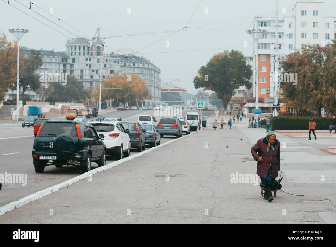 Una vecchia donna cammina giù per la strada principale di Tiraspol, transnistria un auto-dichiarato membro sulla Moldavia-frontiera ucraina Foto Stock
