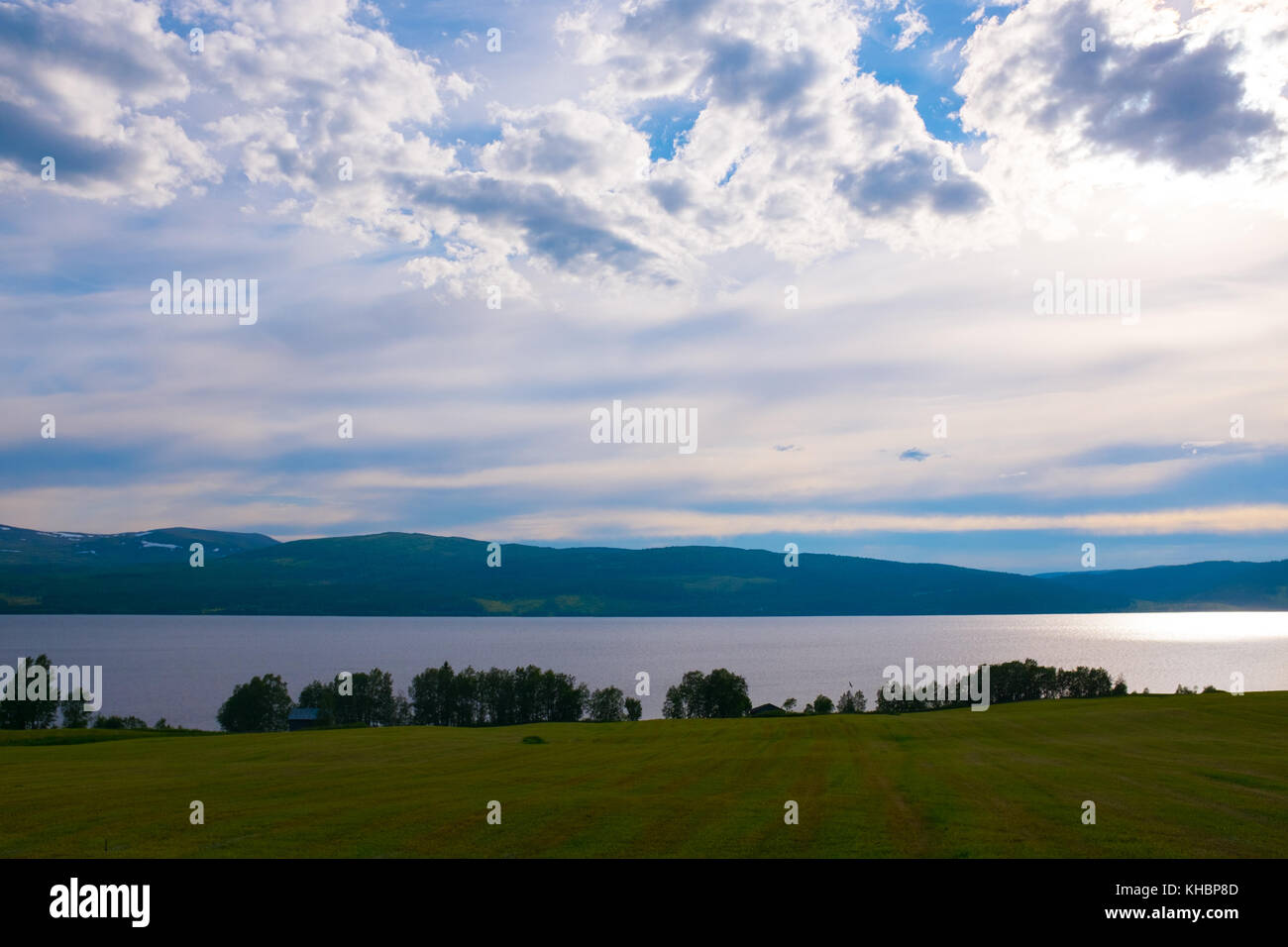 Una soleggiata vista di un lago e campo nella Svezia settentrionale Europa durante una calma summerday Foto Stock