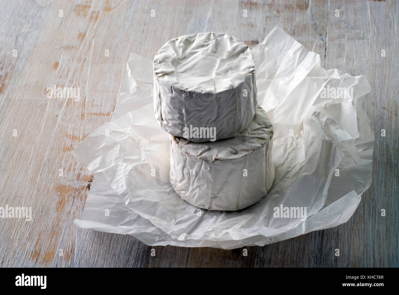 Studio shot di due impilati i formaggi di capra turni non confezionato. Foto Stock