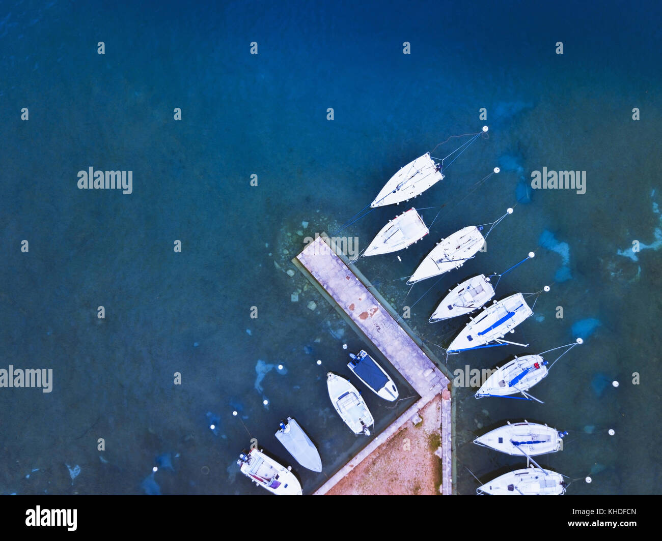 Vista aerea di barche parcheggiata vicino al molo sul lago, acqua blu panorama da fuco Foto Stock