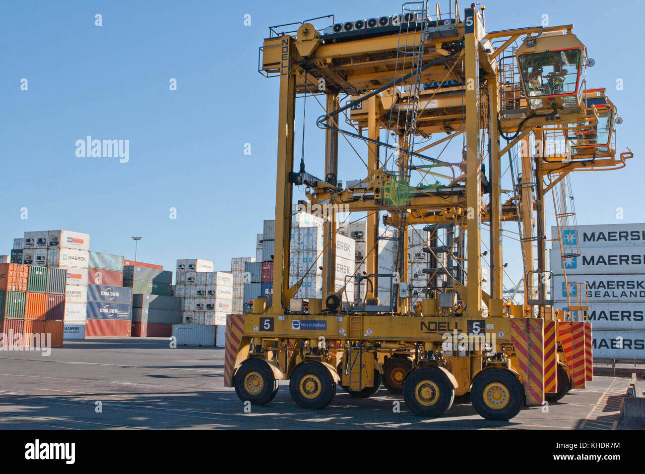 Auckland, Nuova Zelanda - 19 aprile 2012: straddle carrier e la pila di contenitori al porto di Auckland Nuova Zelanda Foto Stock