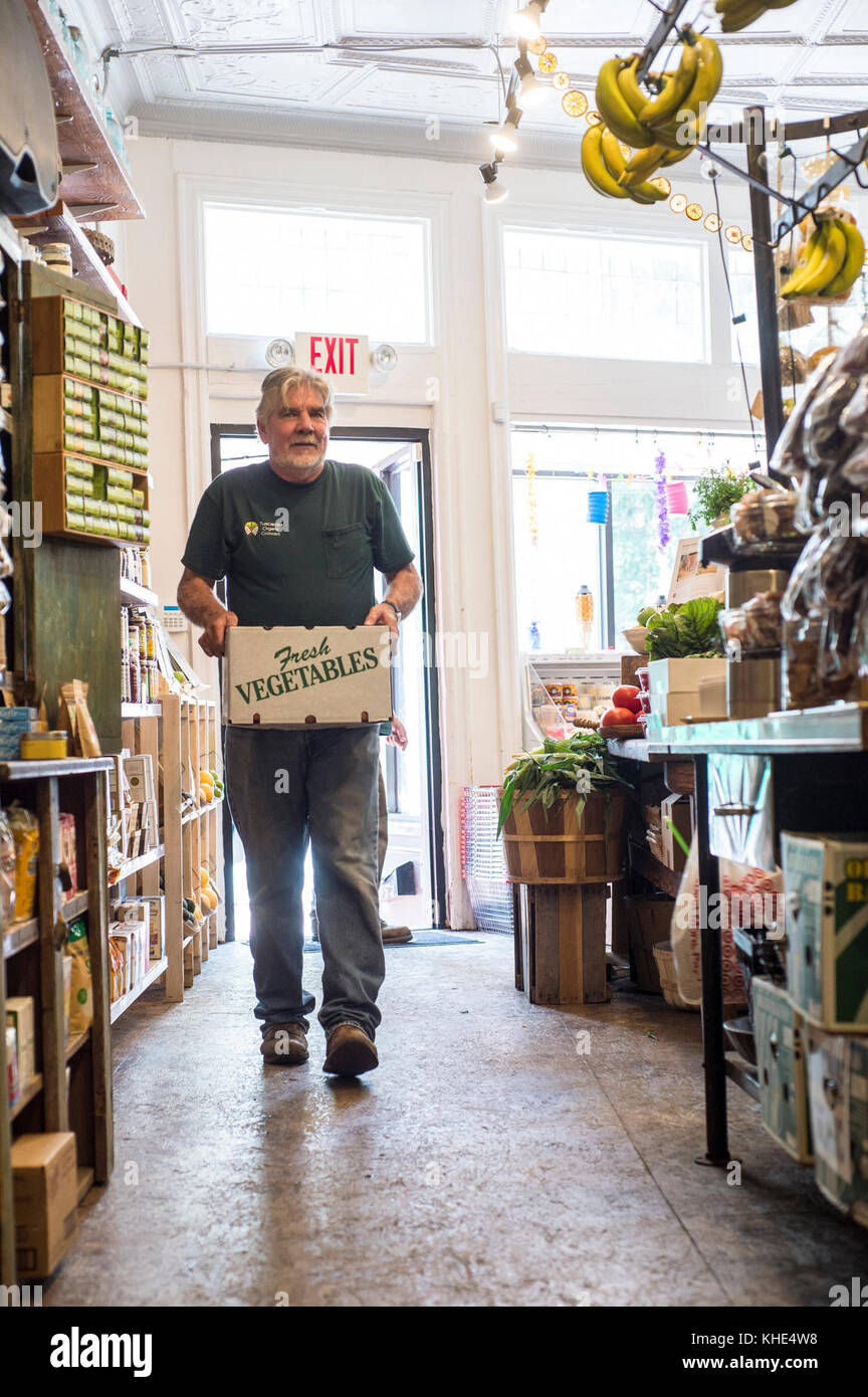 Il driver James Hall dei coltivatori organici di Tuscarora (TOG) consegna i prodotti organici ad ogni mercato di Peach nel Washington, D.C., il 2 agosto 2016. Ogni Peach Market, fondato nel 2013, è un negozio di alimentari a servizio completo che fornisce prodotti, latticini, uova fresche, carne, birra e vino, cibi preparati e molto altro. Il personale è pronto e in grado di raccontare come e dove provengono i cibi e suggerire come preparare i pasti. Jeanelouise Conaway e Emily Freidberg hanno co-proprietario il mercato per, come dicono "…condividere il nostro amore per il buon cibo e lo spirito culinario fai da te con la nostra comunità". Sono caratterizzati da molti grandi p locali Foto Stock