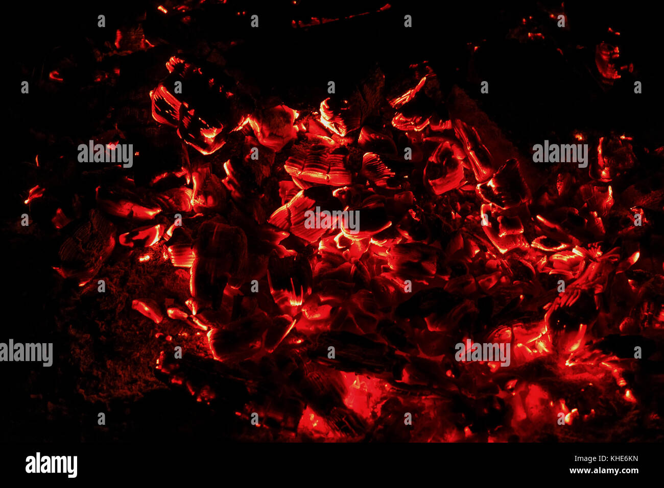 Nero e rosso sfondo astratto di combustioni senza fiamma e carboni ardenti nel fuoco su uno sfondo nero Foto Stock