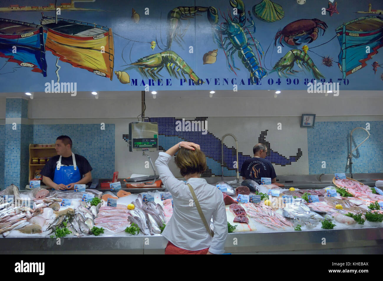 Una donna l'acquisto di pesce fresco a Les Halles il mercato coperto di Avignone, Provenza, Francia Foto Stock