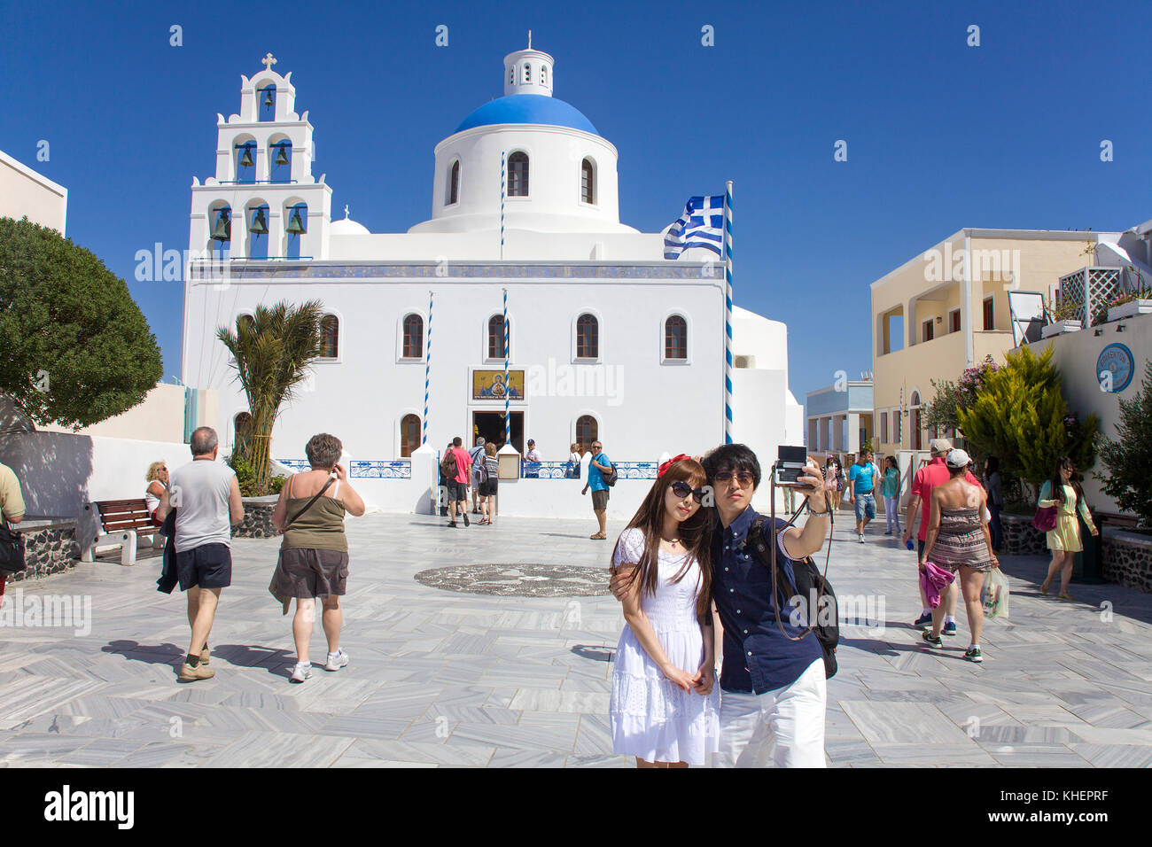 Asian giovane facendo una selfie presso la chiesa di Panagia, Oia, isola di Santorini, Cicladi, Egeo, Grecia Foto Stock