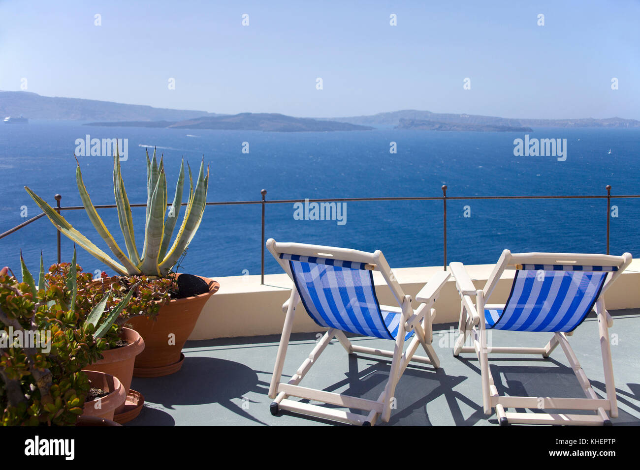 Due sedie a sdraio su una terrazza sul tetto con vista mare, Oia, isola di Santorini, Cicladi, Egeo, Grecia Foto Stock