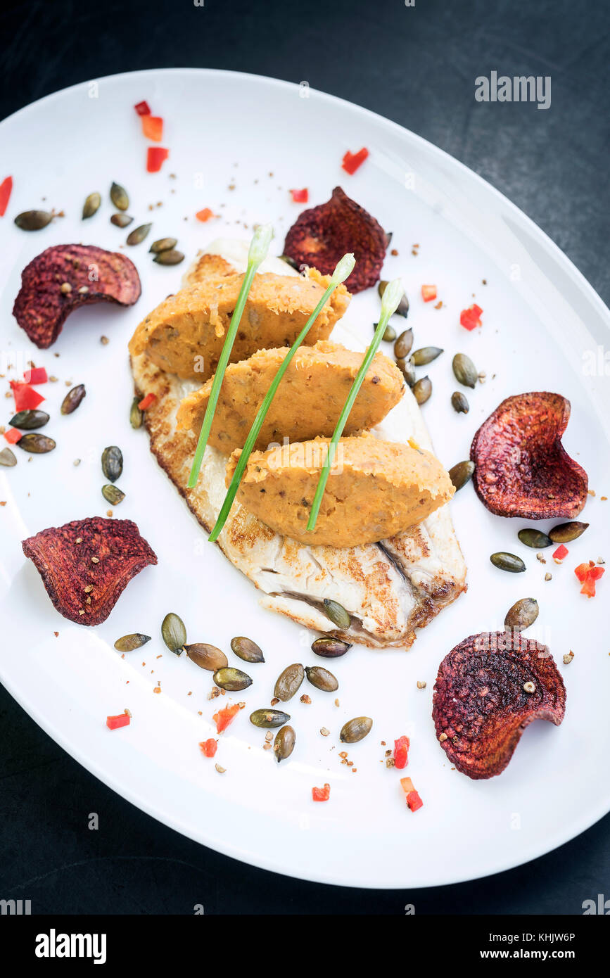 Gourmet filetto di pesce con curry di ceci e purea di barbabietole chips pasto Foto Stock Gourmet filetto di pesce con curry di ceci e purea di barbabietole chips pasto Foto Stock