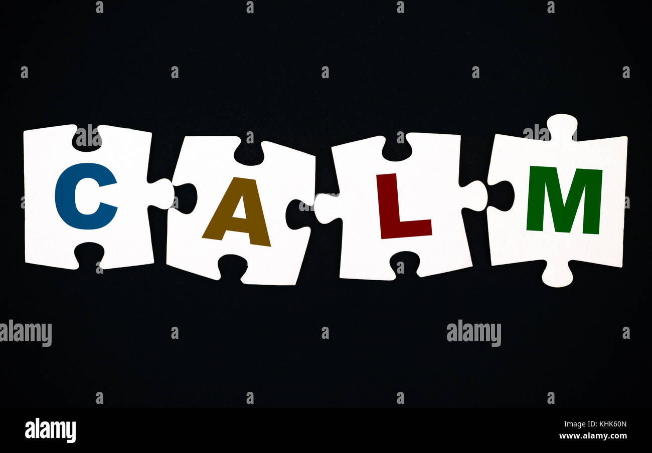 Quattro pezzi di un puzzle con le lettere da c a l m su sfondo nero Foto Stock