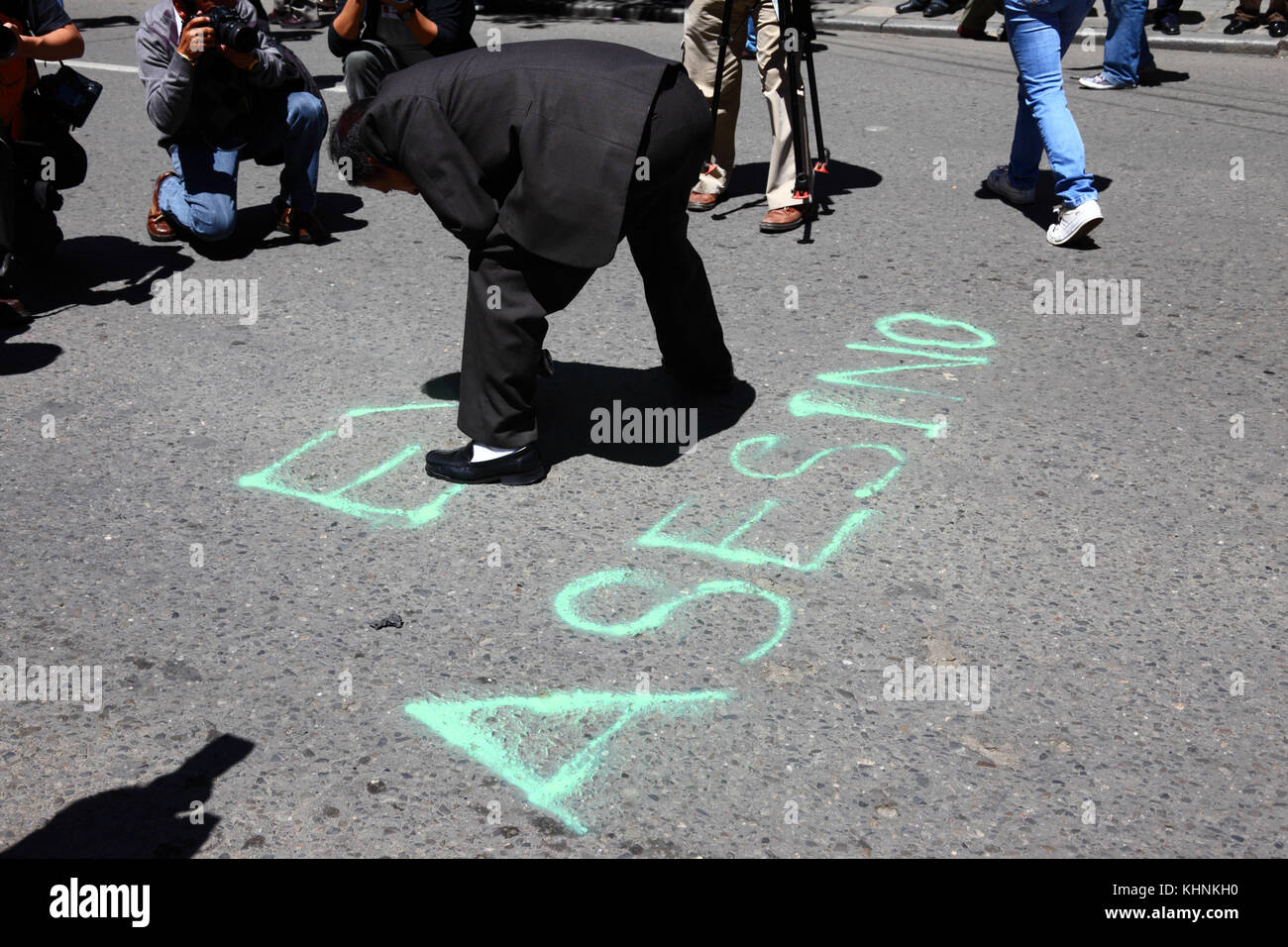Un manifestante vernici Evo Asesino su strada il giorno dopo che la polizia ha invaso il campo della VIII Marzo in difesa del TIPNIS a Chaparina, Bolivia Foto Stock
