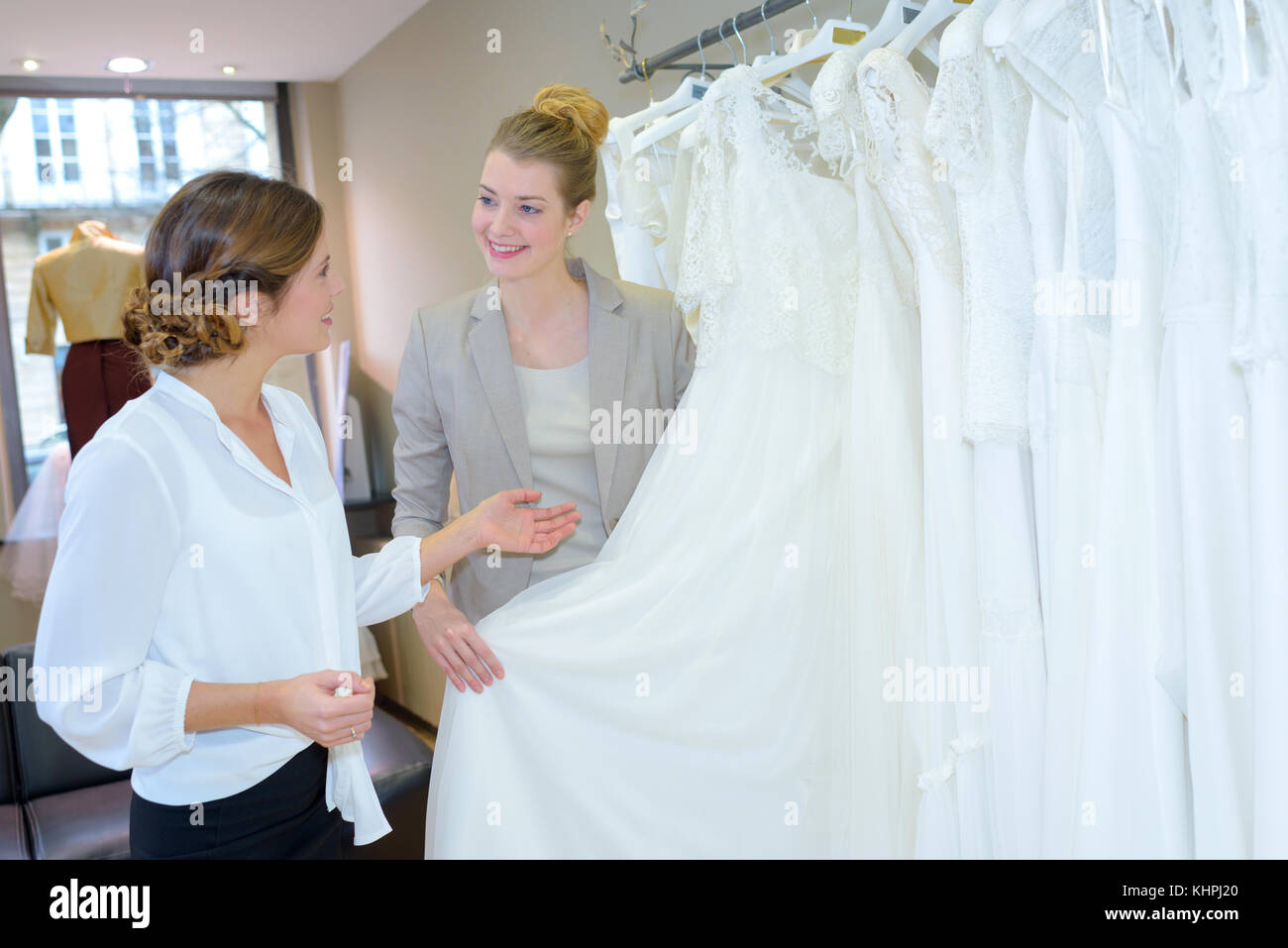 Sposa a fare shopping per abiti da sposa in negozio nuziale Foto Stock