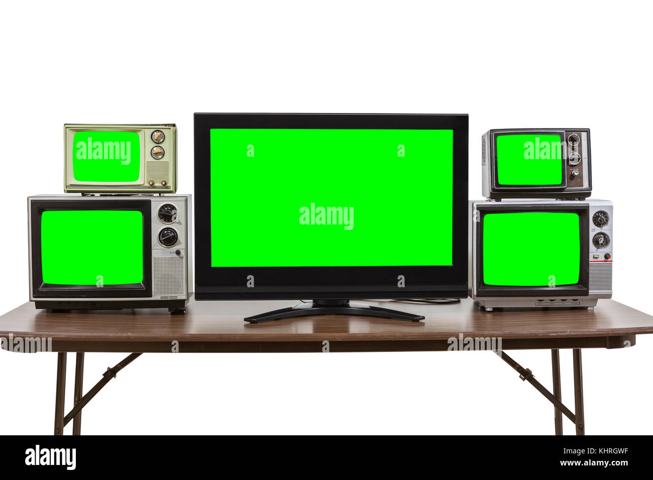 Moderni e vintage televisori sul tavolo isolato su bianco con chroma schermo verde inserti. Foto Stock