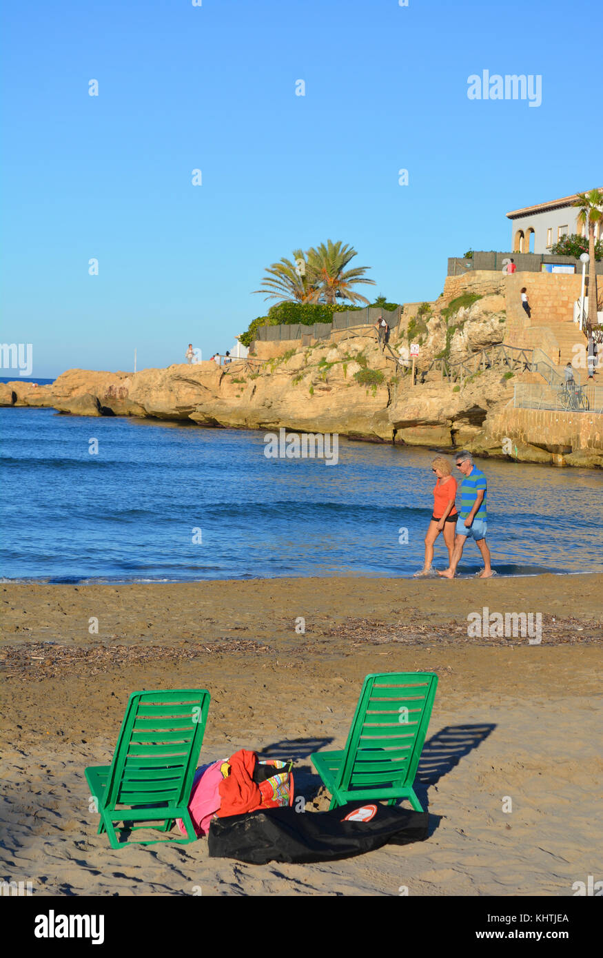 Coppia a piedi al bordo dell'acqua sulla spiaggia Arenal, Javea, Costa Blanca, Spagna Foto Stock