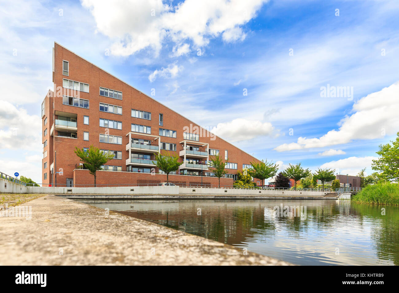 Attraente appartamento complesso con tetto spiovente situato all'acqua durante una soleggiata giornata estiva. Al suburban noordhove nella città zoetermeer, il Foto Stock