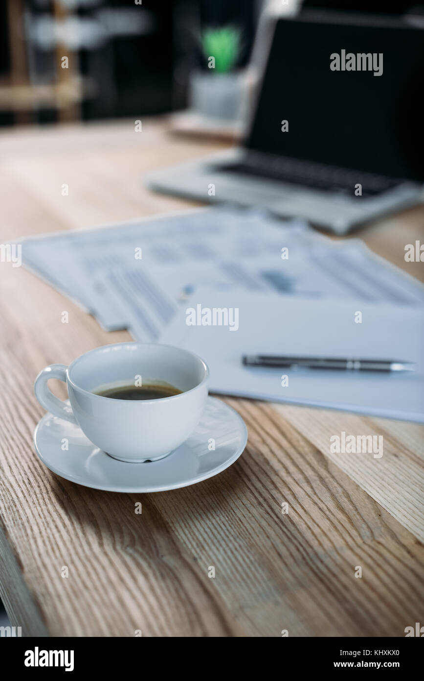 Tazza di caffè e il computer portatile sul tavolo Foto Stock