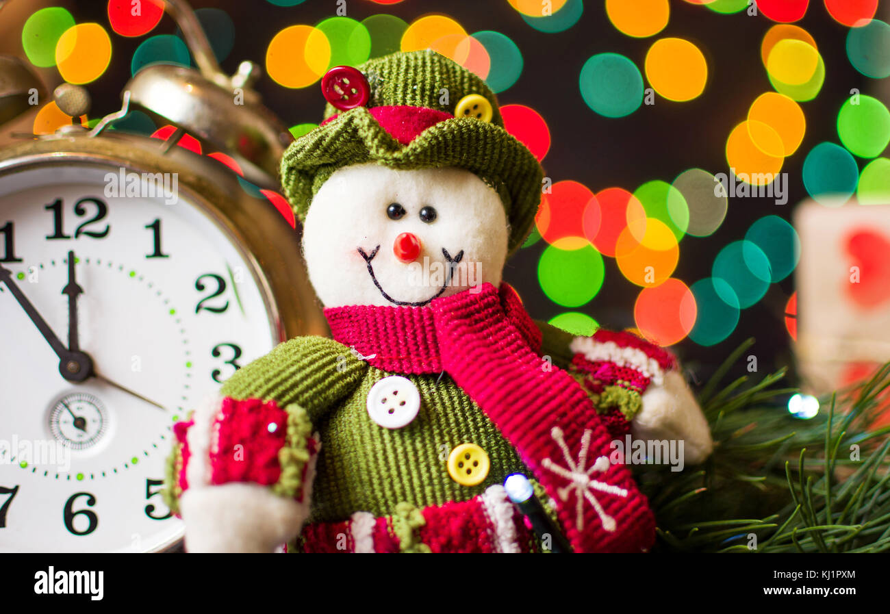 Toy pupazzo di neve contro la festa delle luci di Natale in background Foto Stock