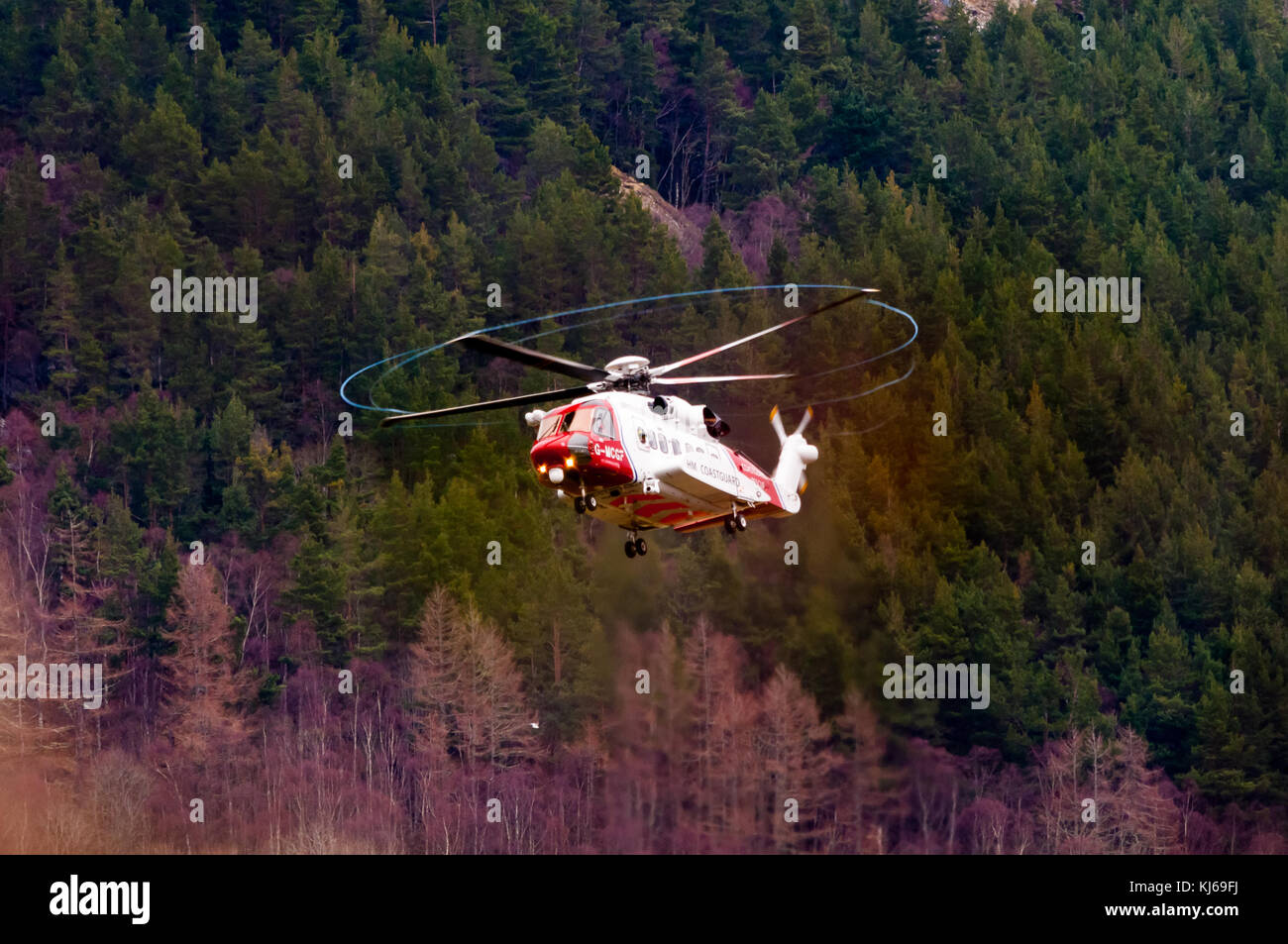 Un hm coastguard sikorsky s92 elicottero cerca un camminatore mancanti vicino ad Inverness nelle highlands scozzesi. Foto Stock