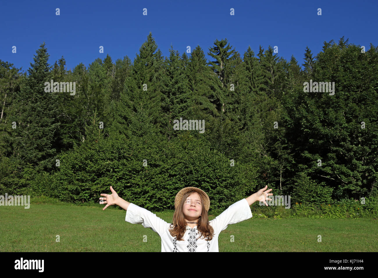 Felice bambina con le mani fino godere nella natura Foto Stock