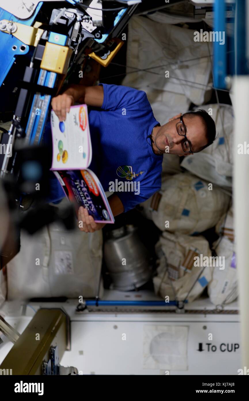 Expedition 53 astronauta americano Joe acaba legge un libro per studenti provenienti da a bordo della Stazione spaziale internazionale novembre 20, 2017 in orbita intorno alla terra. Foto Stock