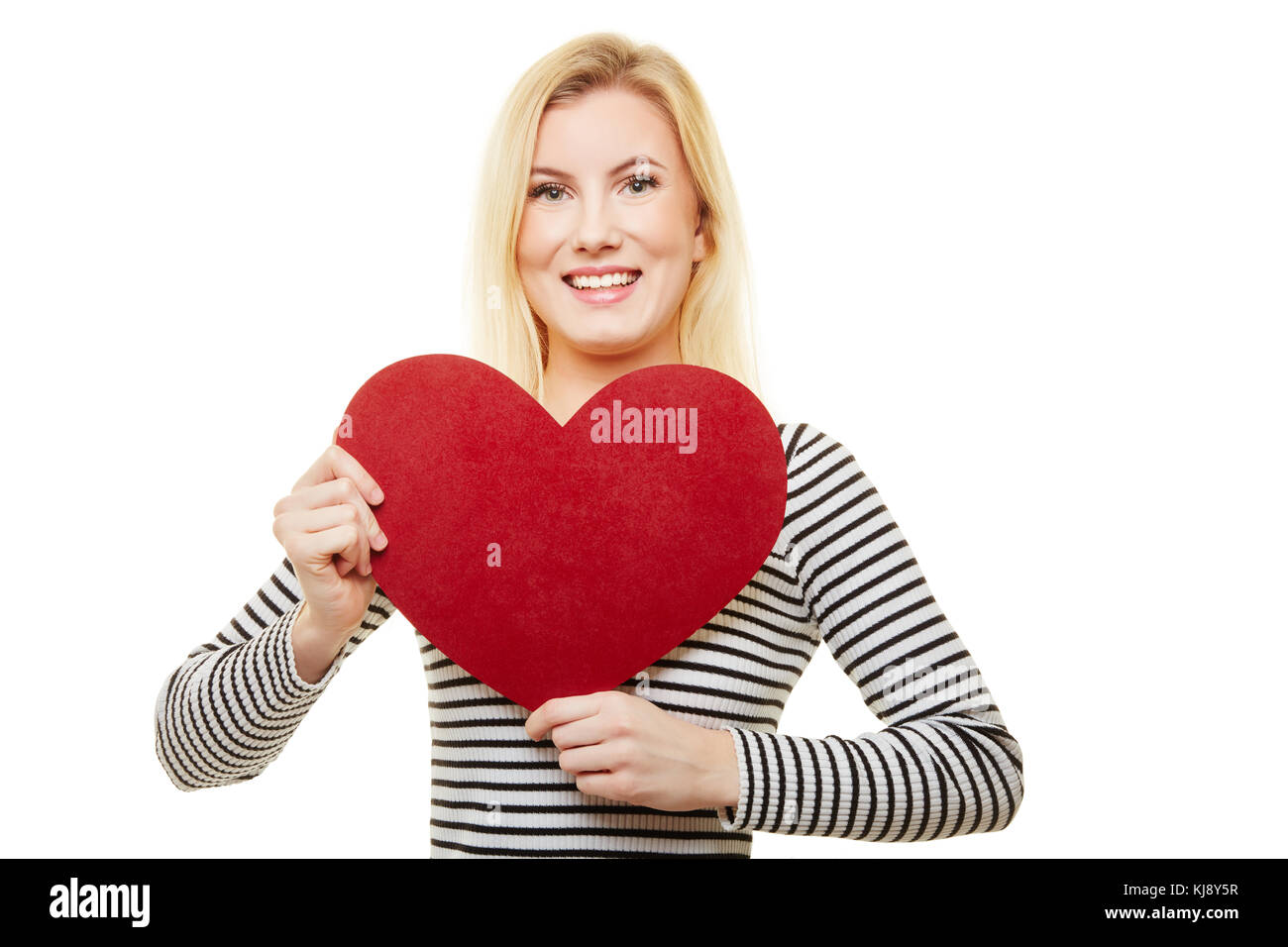 Giovane donna bionda che detiene un grande cuore rosso per il giorno di san valentino o la festa della mamma Foto Stock
