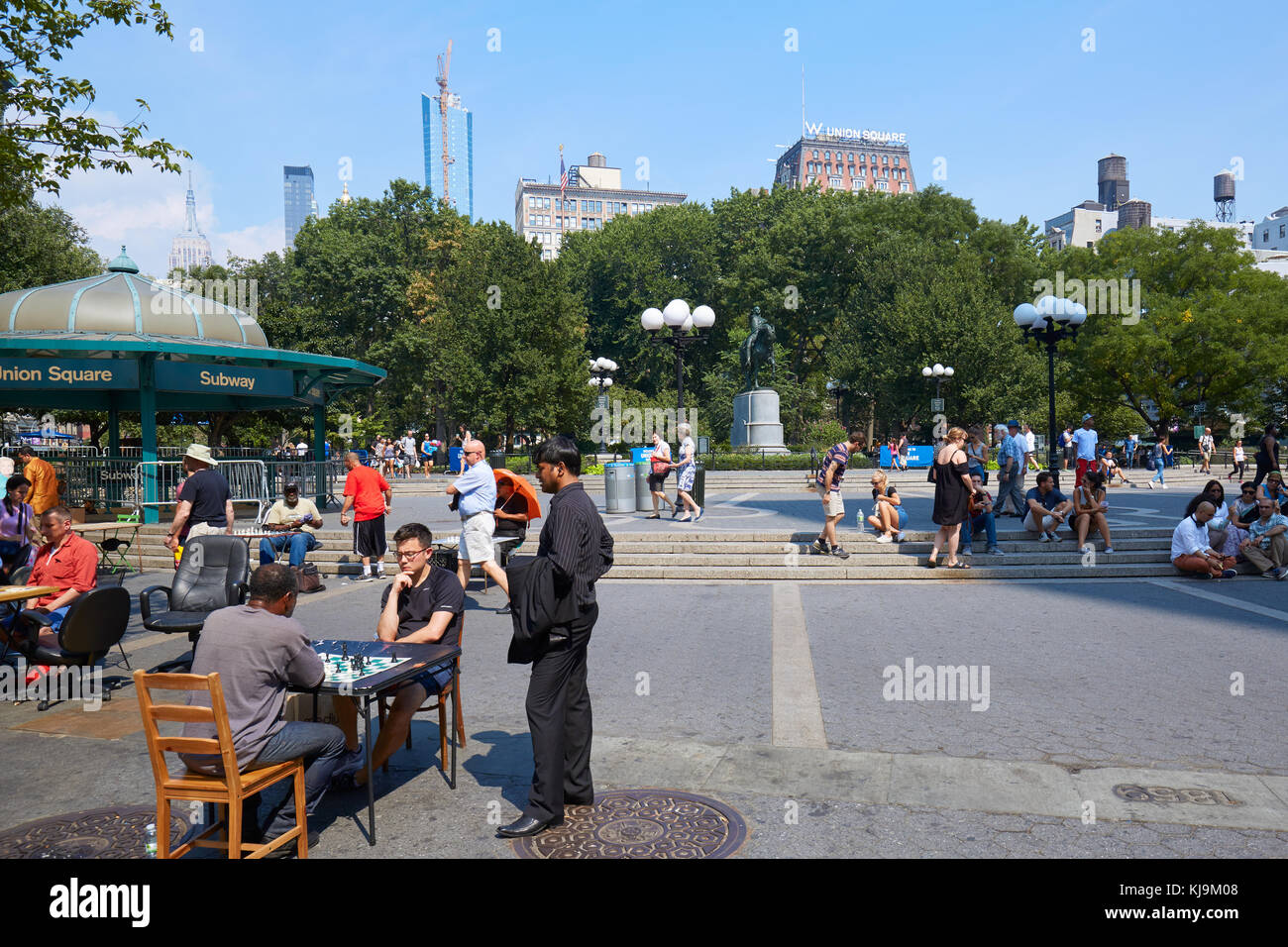 Union Square con i giocatori di scacchi e la gente seduta sui gradini in una giornata di sole in New York Foto Stock