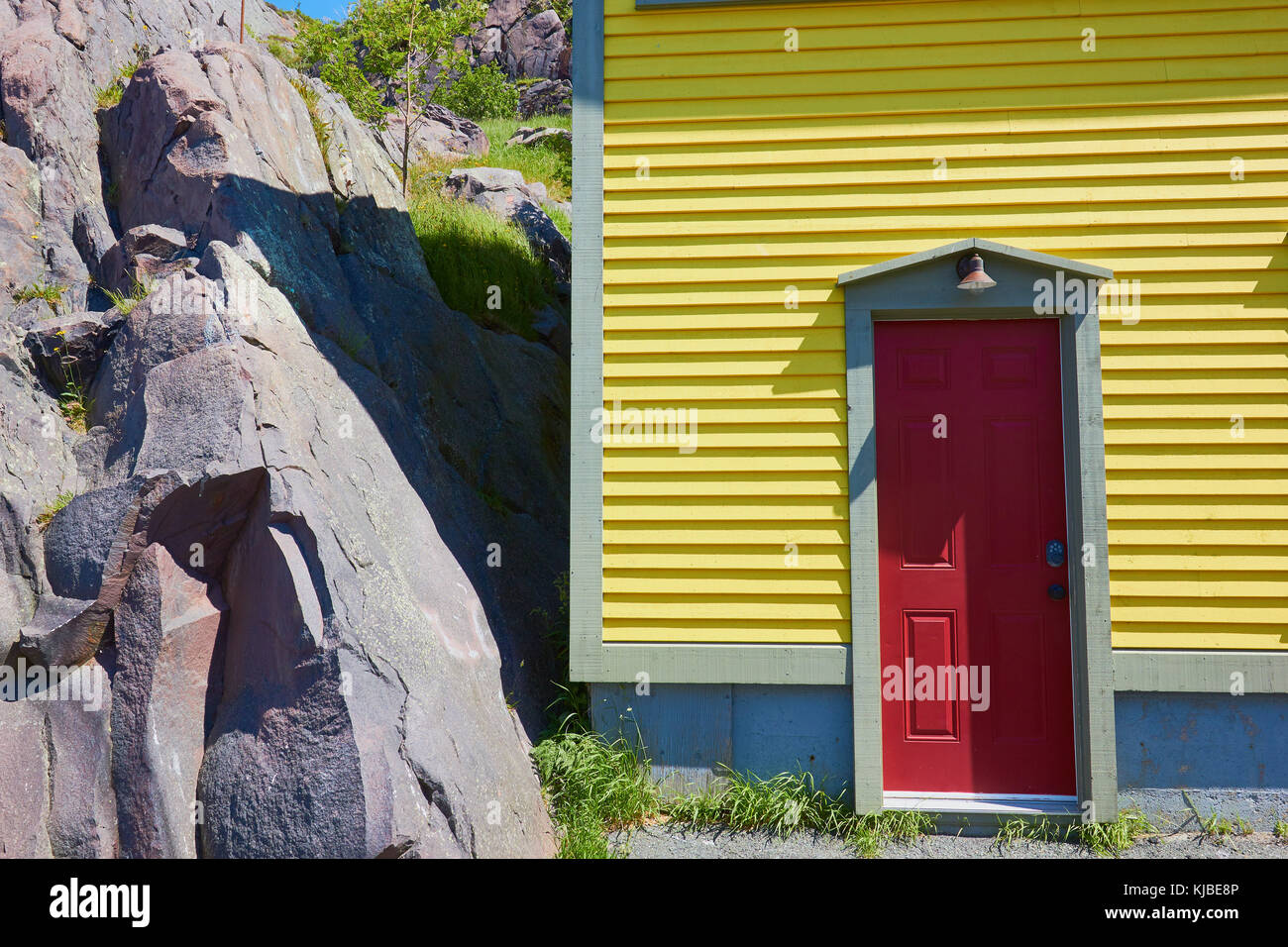 Coloratissima casa gialla con porta rossa nella zona della batteria, Signal Hill, San Giovanni, Terranova, Canada Foto Stock
