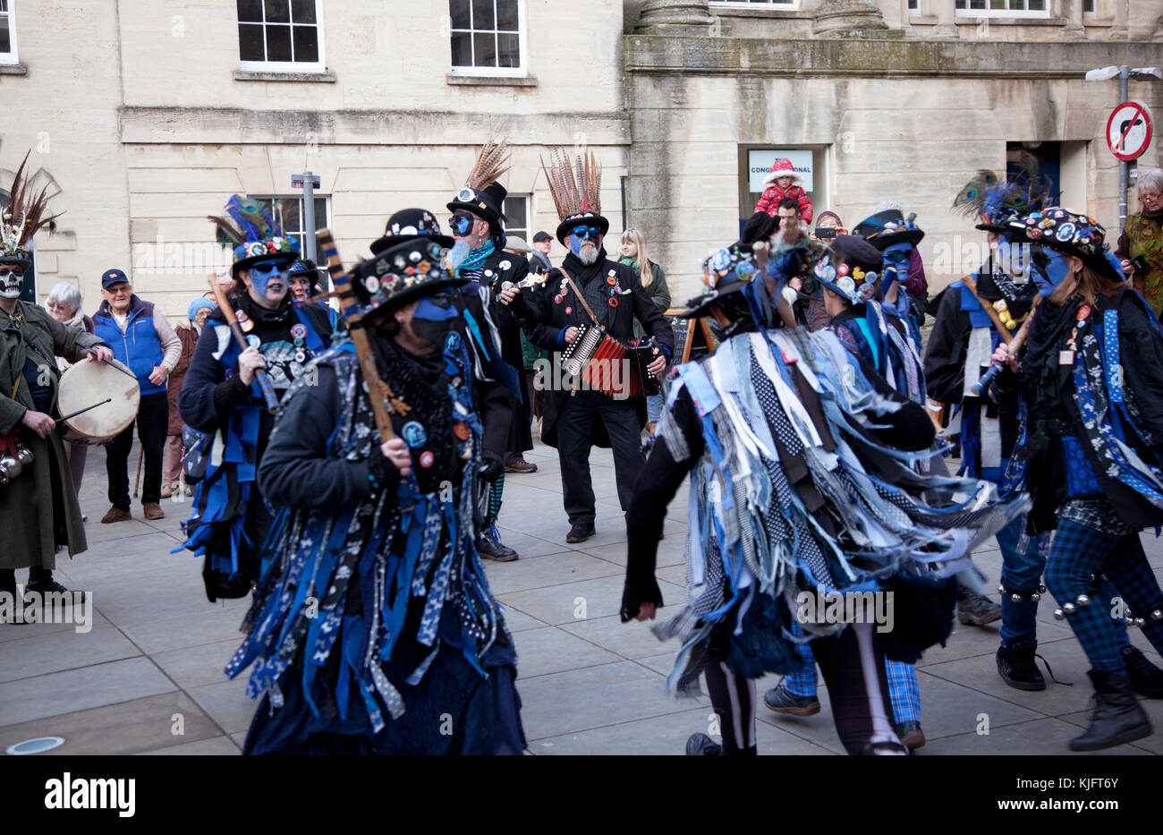 I ballerini di Morris con volti mascherati blu si esibiscono allo Stroud Wassail nella piazza della città di Cotswold Foto Stock