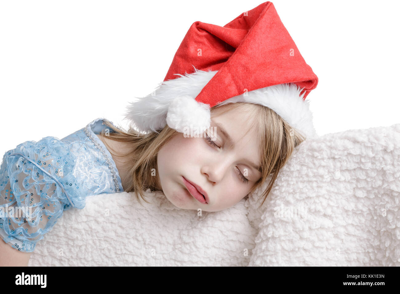 7 anni ragazza dorme nella sleeping beauty dress e santa hat. Foto Stock