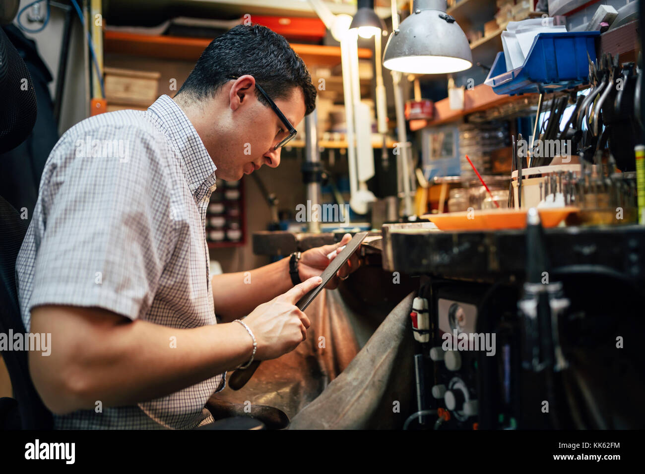 Artigiano al lavoro presso la sua tabella Foto Stock