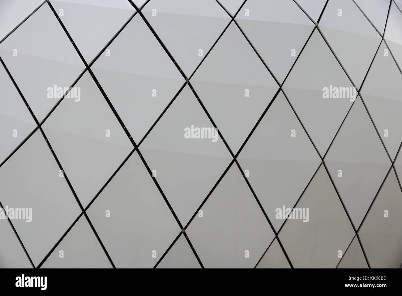 Dettaglio di una circolare della facciata di un edificio di moderna costruzione fatta di pannelli sandwich sul cielo blu sullo sfondo Foto Stock