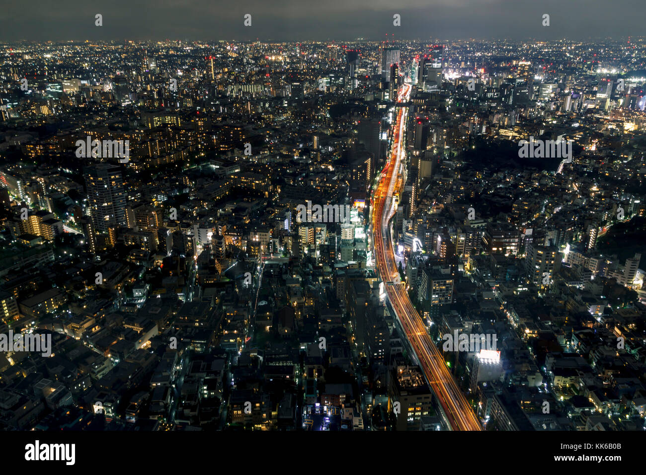 La vista della citta' di Tokyo di notte con una autostrada che attraversa gli edifici Foto Stock