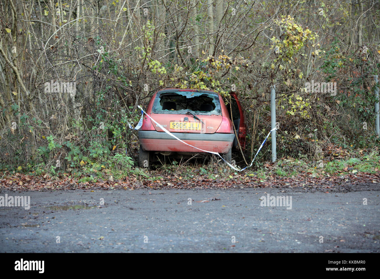 Un auto abbandonate che si è schiantato in una siepe su una strada rurale nel Wiltshire, Inghilterra. Foto Stock