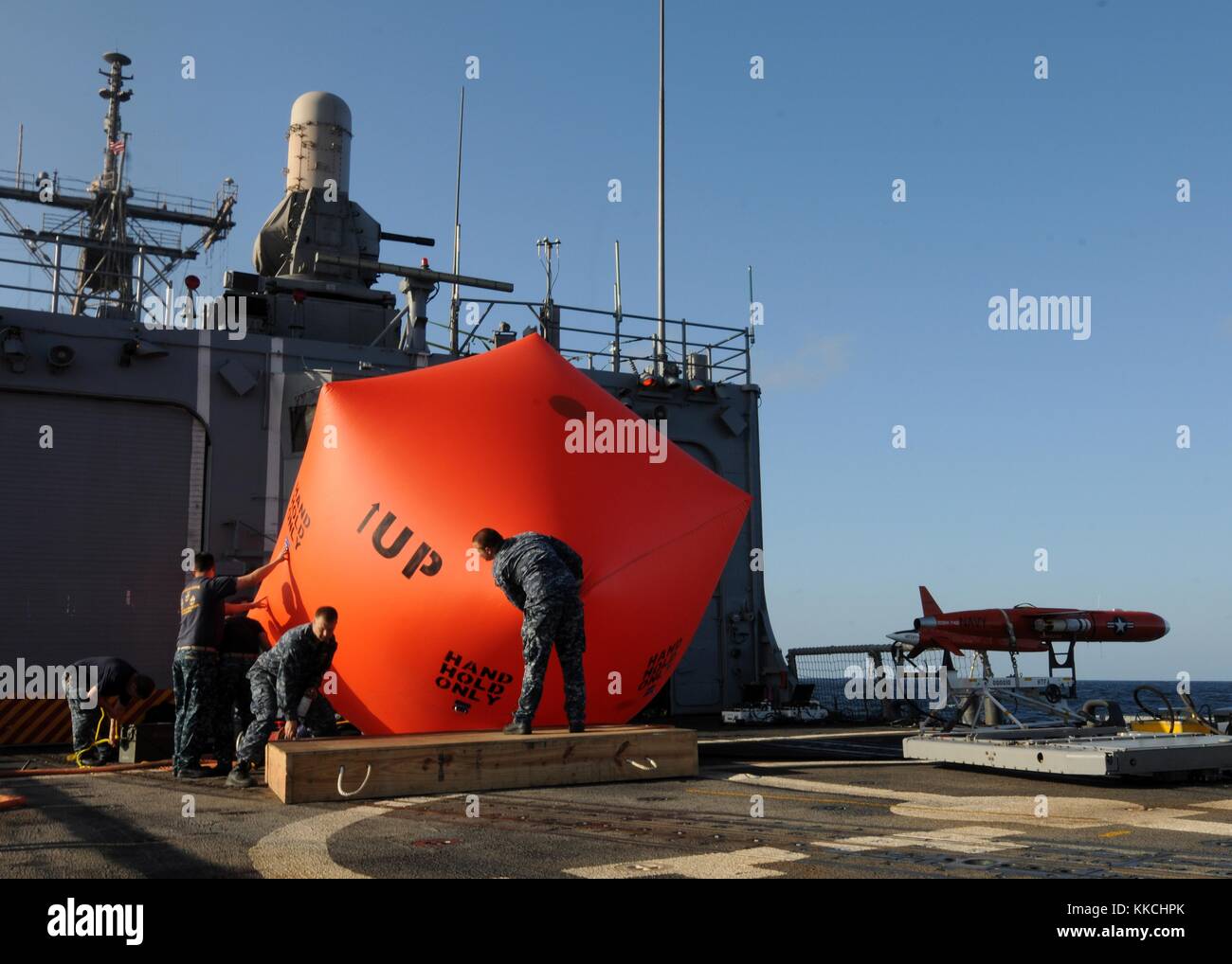 I marinai gonfiano il "pomodoro assassino" sul ponte di volo della fregata missilistica guidata classe Oliver Hazard Perry USS Underwood FFG 36 prima di lanciarlo in acqua prima di iniziare esercitazioni di fuoco vivo, nell'Oceano Pacifico. Immagine gentilmente concessa da Stuart Phillips/US Navy, specialista comunicazioni di massa di seconda classe. 2012. Foto Stock