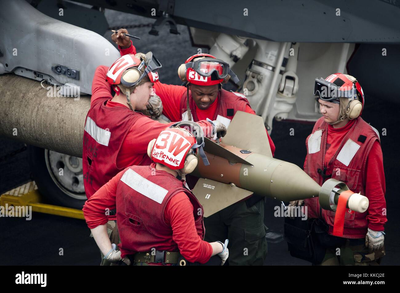 Aviation ordnancemen assegnati alle aquile di strike fighter Squadron VFA 115 braccio una GBU-16 Paveway II su un f/a-18e durante le operazioni di volo a bordo della portaerei USS George Washington cvn 73, oceano pacifico, 2012. Immagine cortesia la comunicazione di massa specialista di terza classe paul kelly/us navy. Foto Stock