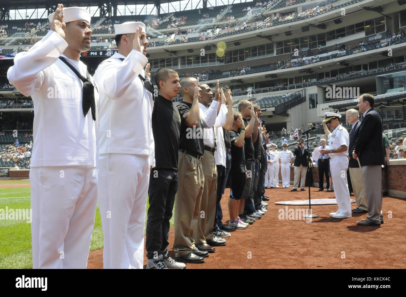 Diversi membri del servizio e membri del programma di ammissione ritardata recitano il giuramento di arruolamento con il contrammiraglio Herman A Shelanski, comandante del Carrier Strike Group 10, prima di una partita della Major League Baseball durante la Fleet Week New York 2012, New York. Per gentile concessione di Mass Communication Specialist Seaman Karen Blankenship/US Navy, 2012. Foto Stock