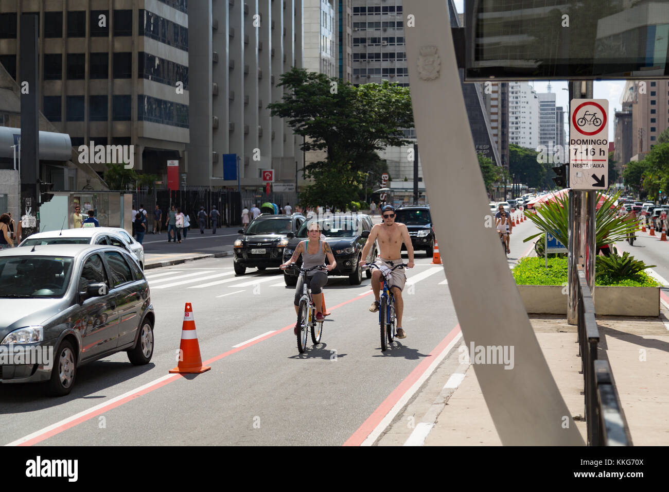 I ciclisti sulla pista ciclabile lungo la Avenida Paulista (Paulista Avenue) durante il caldo pomeriggio soleggiato Domenica, Sao Paulo, Brasile Foto Stock