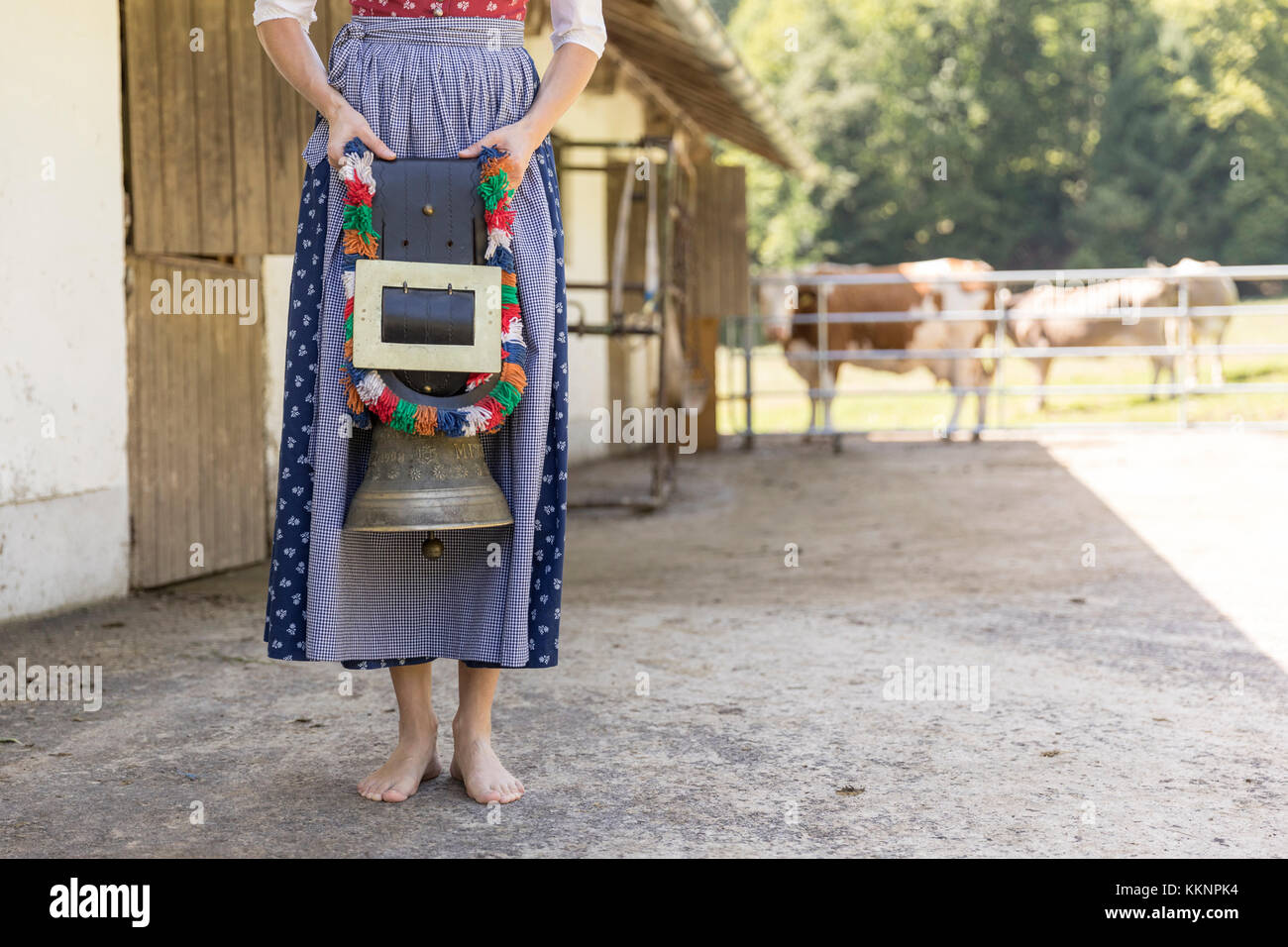 Contadino con dirndl portante un campanaccio Foto Stock