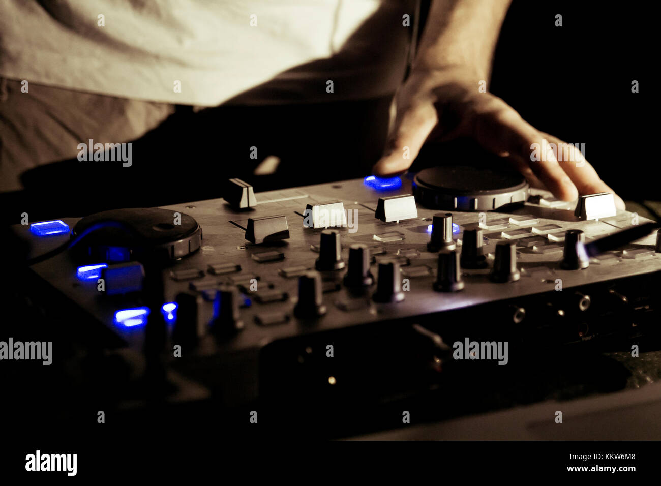 Il dj utilizza una console di mixaggio per gestire la musica elettronic. Foto Stock